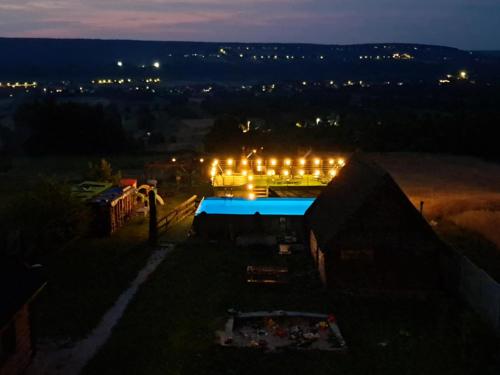 a night view of a building with lights on it at Noclegi u Banysia w sercu Gór Świętokrzyskich in Krajno Pierwsze