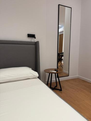 a bedroom with a bed and a mirror at Vironas Hotel in Himare