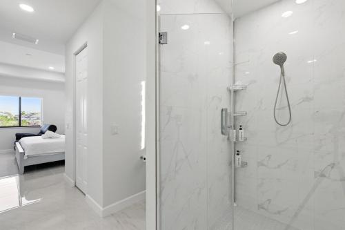 un bagno con doccia con porta in vetro di Canal's Breeze a Cape Coral
