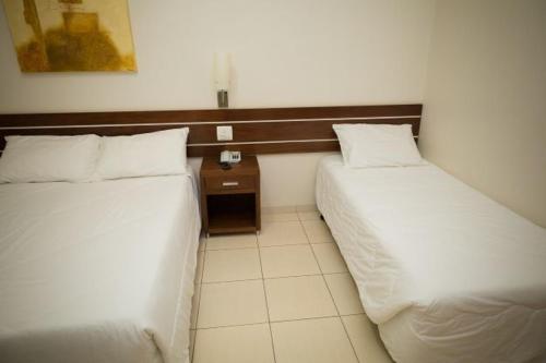 Postel nebo postele na pokoji v ubytování Real Palace Hotel