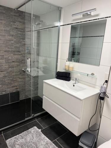 a bathroom with a white sink and a shower at Ferienwohnung für Gruppen oder Familien in Schönwies
