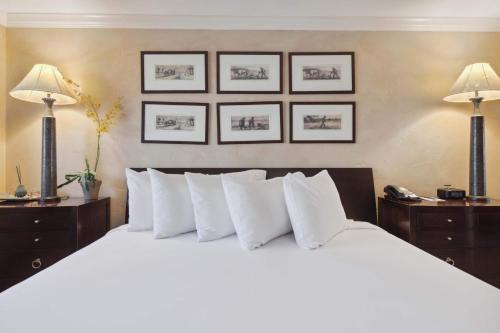 a bedroom with a large white bed with three pictures on the wall at Lodge Tower 690 in Vail