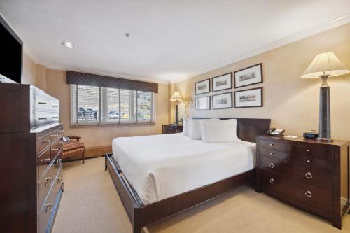 a hotel room with a bed and a television at Lodge Tower 690 in Vail