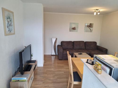 a living room with a couch and a table at Ferienwohnung Dressler in Wolfegg