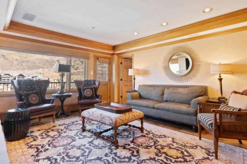 a living room with a couch and a table at Lodge Tower 694 Two Bedroom Residence in Vail