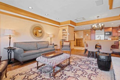 a living room with a couch and a table at Lodge Tower 694 Two Bedroom Residence in Vail