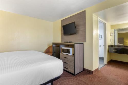 a hotel room with a bed and a tv at SureStay by Best Western Chambers Petrified Forest in Chambers