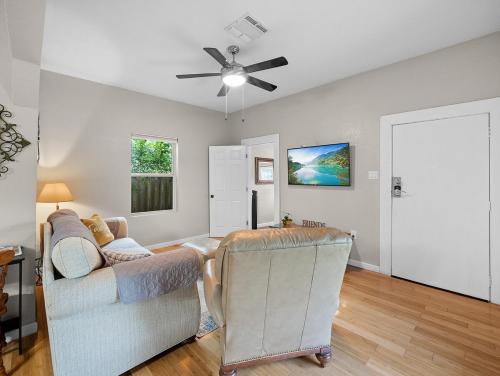 a living room with a couch and a ceiling fan at 6 min from River center mall and hospital in San Antonio