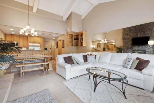 a living room with a white couch and a table at Lodge Tower 778 Two Bedroom Residence in Vail