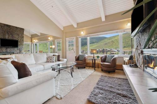 a living room with a white couch and a fireplace at Lodge Tower 778 One Bedroom Residence in Vail