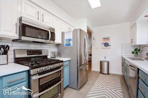 a kitchen with a stove and a refrigerator at Peaceful home with fire pit and game room in Denver