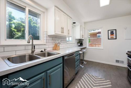 a kitchen with a sink and a window at Peaceful home with fire pit and game room in Denver