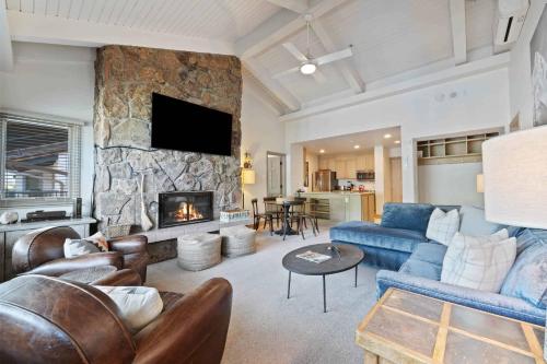 a living room with a couch and a fireplace at Lodge Tower 786 Two Bedroom Residence in Vail