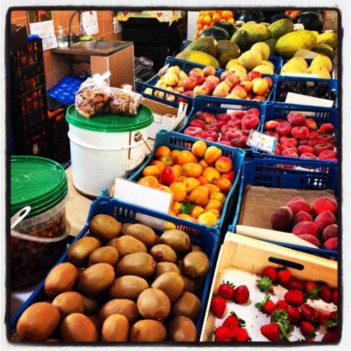 a display of fruits and vegetables in blue baskets at Al-Gharb Tavira Eco GuestHouse in Tavira