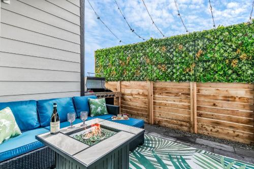 a patio with a blue couch and a table at 10 min to DT, Luxe 4BR w Movie Theater, Game Room in Commerce City