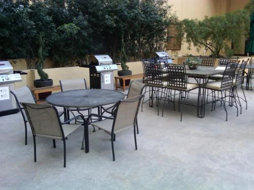a group of tables and chairs in a patio at Jockey Resort Suites Center Strip in Las Vegas