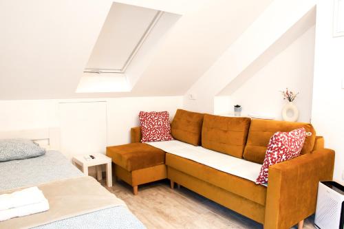 a living room with a couch and a bed at Six Lamps on Masarykova in Zagreb