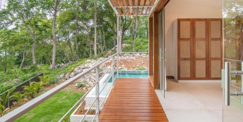 a house with a view of a pool and trees at Villa Laia - Santa Teresa in Santa Teresa Beach