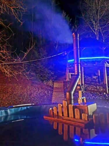 a playground at night with blue lights at Cabana Oops Foisorul ascuns in Vama