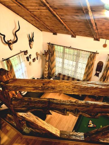 a living room with a large log bed in a house at Cabana Oops Foisorul ascuns in Vama
