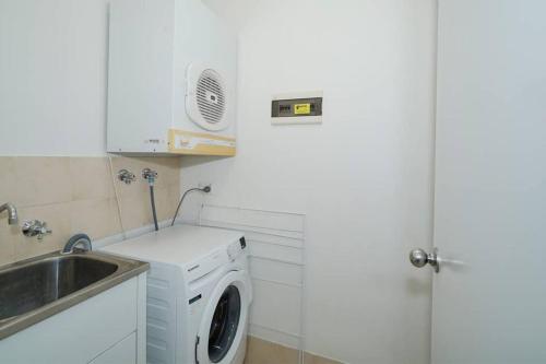 a kitchen with a washing machine and a sink at Classic East Perth - Close To Optus Stadium in Perth