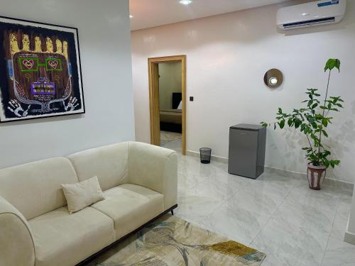 a living room with a couch and a television at City Styles in Abuja