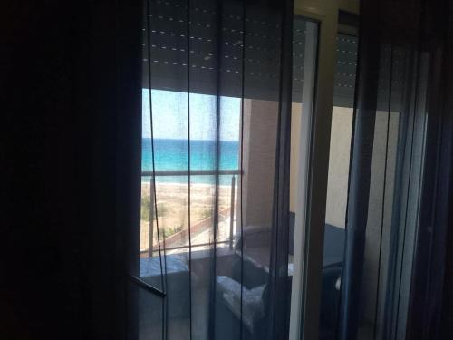 a view of the ocean from a window at Noa Coast in Akouda