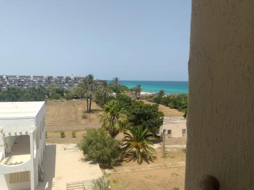 a view of the beach from the balcony of a building at Noa Coast in Akouda