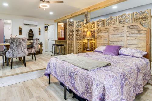 a bedroom with a large bed and a dining room at 7 Mi to Kitty Hawk Pier and Beach Studio with Patio! 