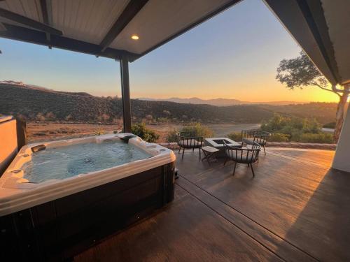 a hot tub on the deck of a house with a view at Ultimate Winery Getaway With Spa And Amazing Hilltop View in Temecula