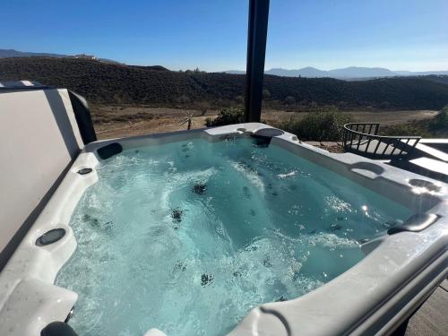 a jacuzzi tub with a view of the desert at Ultimate Winery Getaway With Spa And Amazing Hilltop View in Temecula
