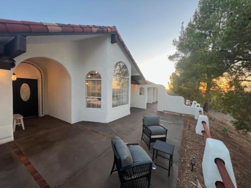 a patio of a house with chairs and tables at Ultimate Winery Getaway With Spa And Amazing Hilltop View in Temecula