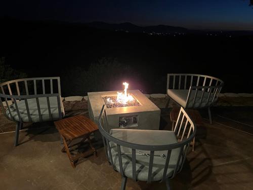 three chairs and a table with a candle on it at Ultimate Winery Getaway With Spa And Amazing Hilltop View in Temecula