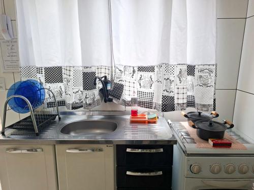 a kitchen with a sink and a counter top at Kitnet Lua - Mobiliada in Belo Horizonte