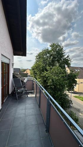 a balcony with a table and chairs on it at Ferienhaus "Rommelhäuser" in Nidderau