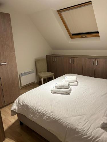 a bedroom with a bed with towels on it at Rotessa in Blankenberge