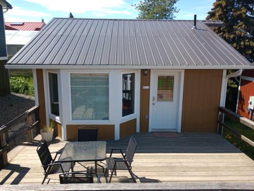 a house with a porch with chairs and a door at Sky Harbor Cabin - Homer Seaplane Base in Homer