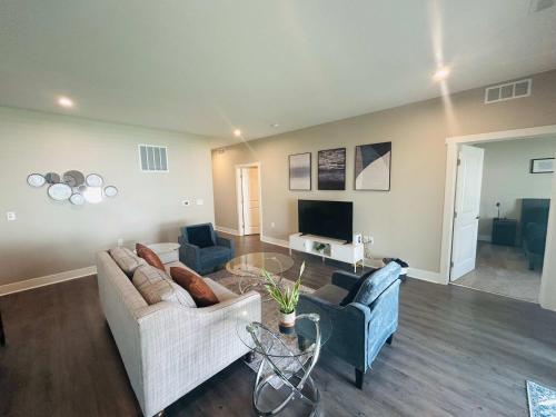 a living room with two couches and a tv at Spacious Wyoming MI Getaway- Minutes to GR in Wyoming