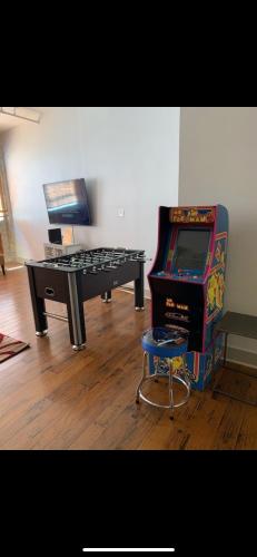 a room with a piano and a video game at Creole Nest in New Orleans