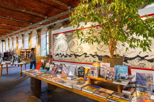 a table with books on it in a book store at World Heritage Saltaire Stylish Cottage in Saltaire
