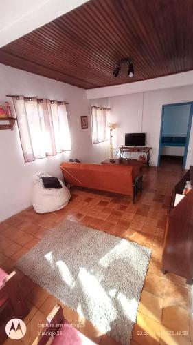 a large living room with a bed and a table at Casa de temporada 3 quartos in São Bento do Sapucaí