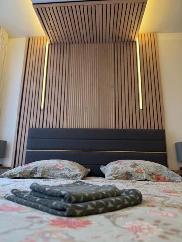 a bed with two pillows and a large headboard at l hibou in Avranches