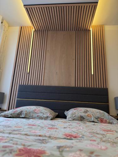 a bedroom with a bed with two pillows on it at l hibou in Avranches