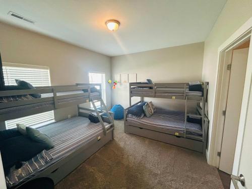 a room with two bunk beds in it at Spacious Wyoming MI Getaway- Minutes to GR in Wyoming