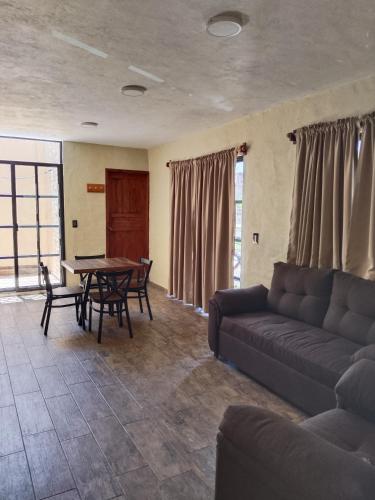 a living room with a couch and a table at Hotel Spa el Gran Coral in San Juan Cosalá