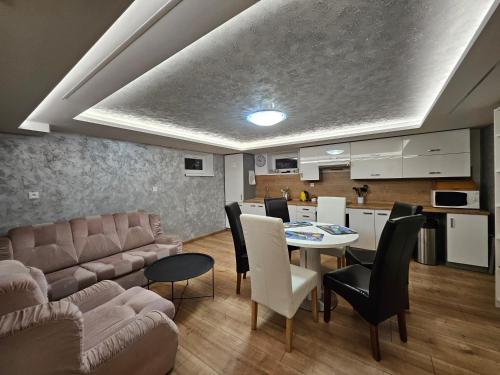 a living room with a couch and a table at Wellness Toliar Tatry in Stará Lesná