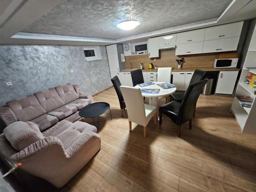 a living room with a couch and a table at Wellness Toliar Tatry in Stará Lesná