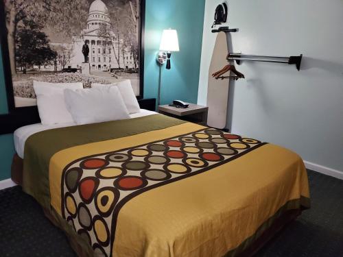 a hotel room with a large bed in a room at River Hill Inn & Suites in Hudson