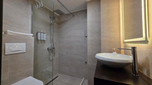 a bathroom with a shower with a sink and a toilet at Guest House Marli in Ohrid
