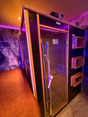an empty elevator in a room with purple lights at Love Room Attitude in Grenoble